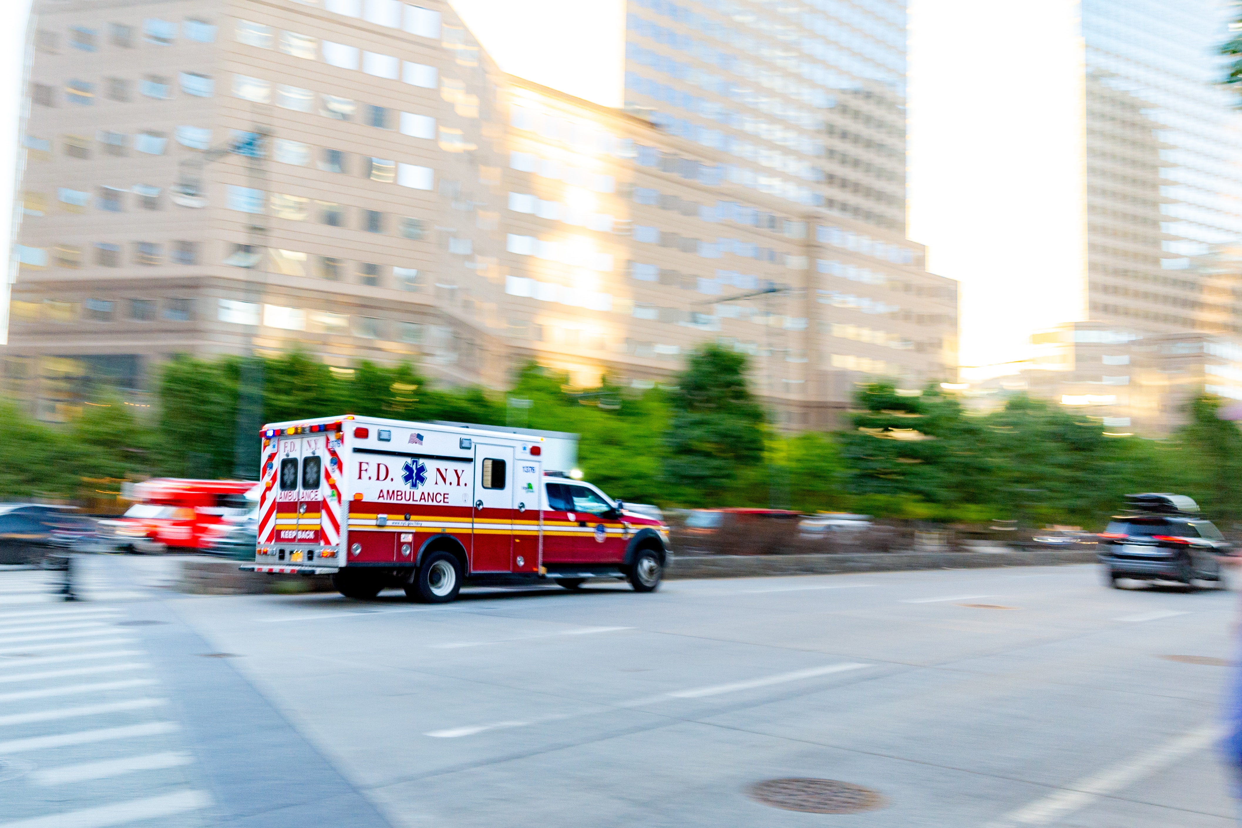 An ambulance moving through city traffic